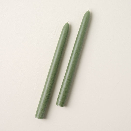 two colonial green taper candles