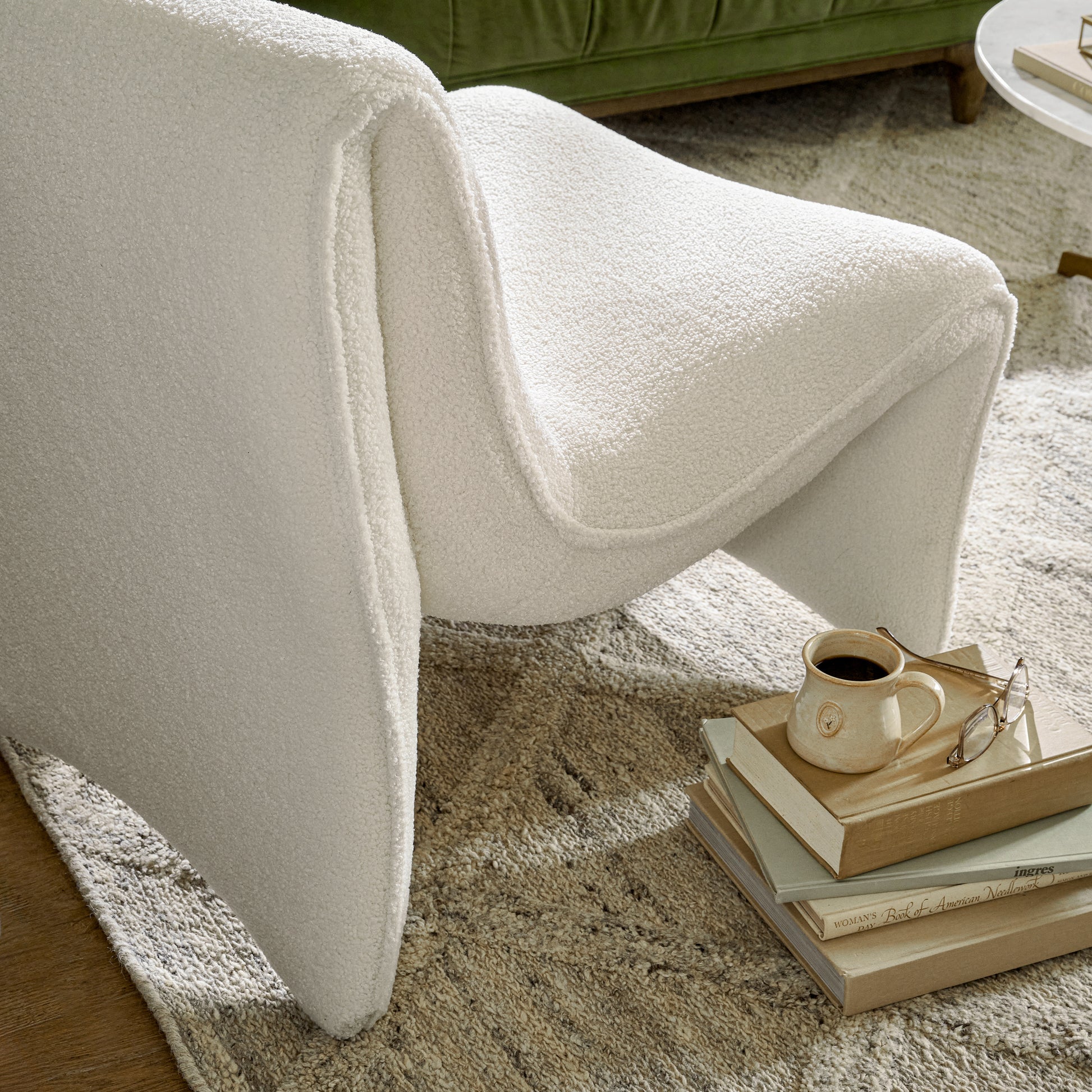 jasmine chair close up in a living room next to a stack of books 