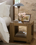 Brooke End Table in a room with bouquet flowers in brass vase and petal scalloped table lamp and framed art on top