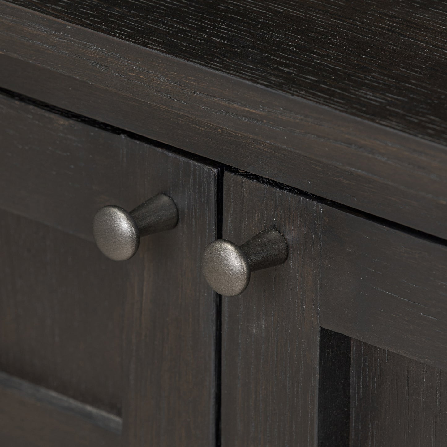 Cara Bookcase zoomed in view of bottom cabinet doorknobs
