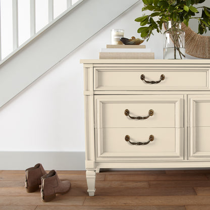 Morning Snow paint shown on vintage-inspired furniture piece with stacked books on top and florals inside vase