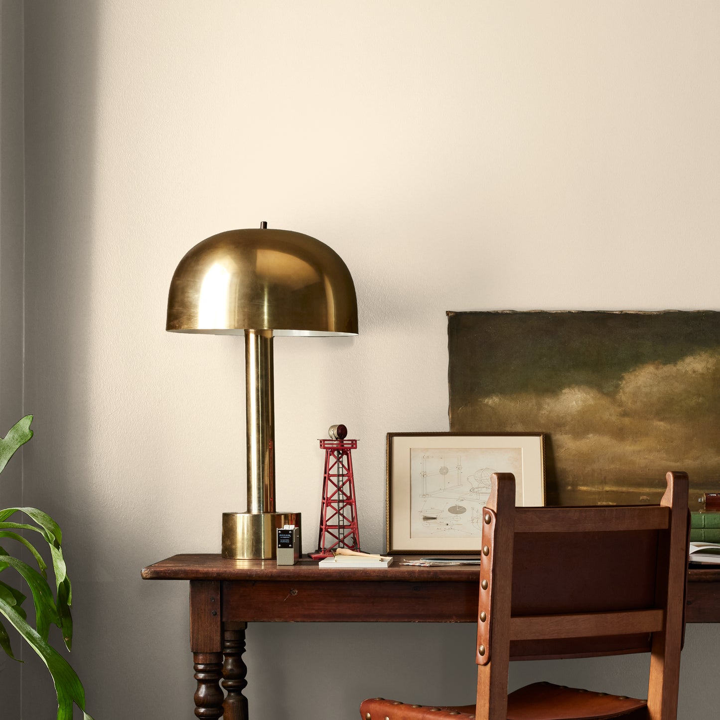 Morning Snow paint featured in office area wall with brass lamp, wood table and desk chair, pictures