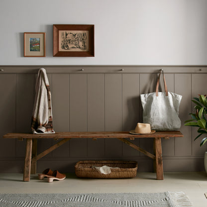 Mosswood paint featured in mudroom on half room paneled walls with hung tote bag and cardigan