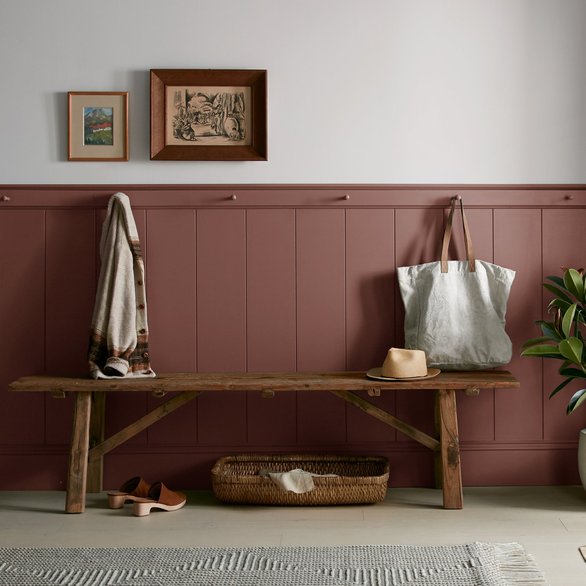 Mountain Currant paint featured in mudroom on half room paneled walls with hung tote bag and cardigan