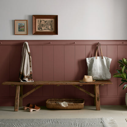 Mountain Currant paint featured in mudroom on half room paneled walls with hung tote bag and cardigan