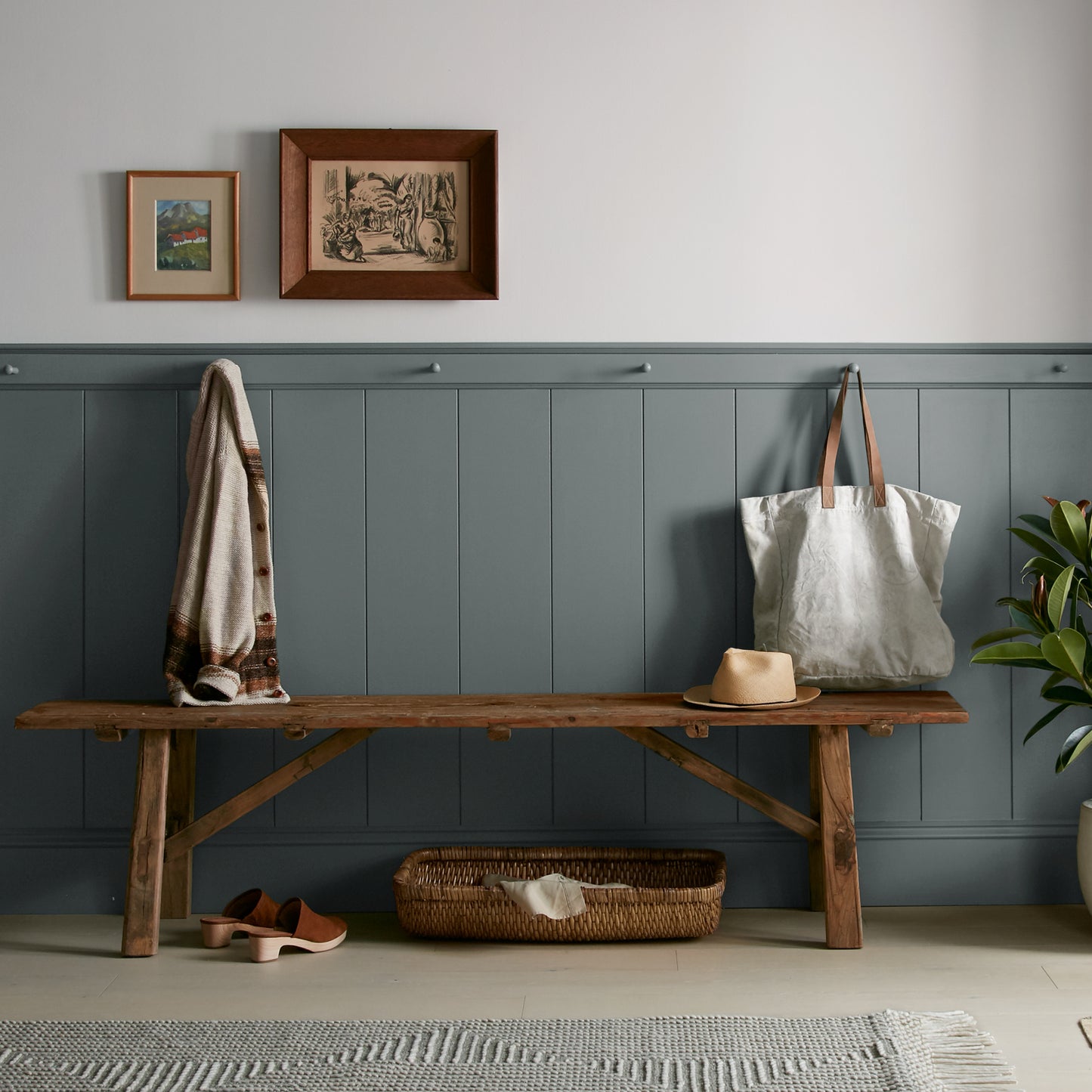 Ridge Rock paint featured in mudroom on half room paneled walls with hung tote bag and cardigan