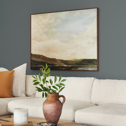 Ridge Rock paint featured in living room walls with large landscape picture above cream sectional and brown vase and greenery