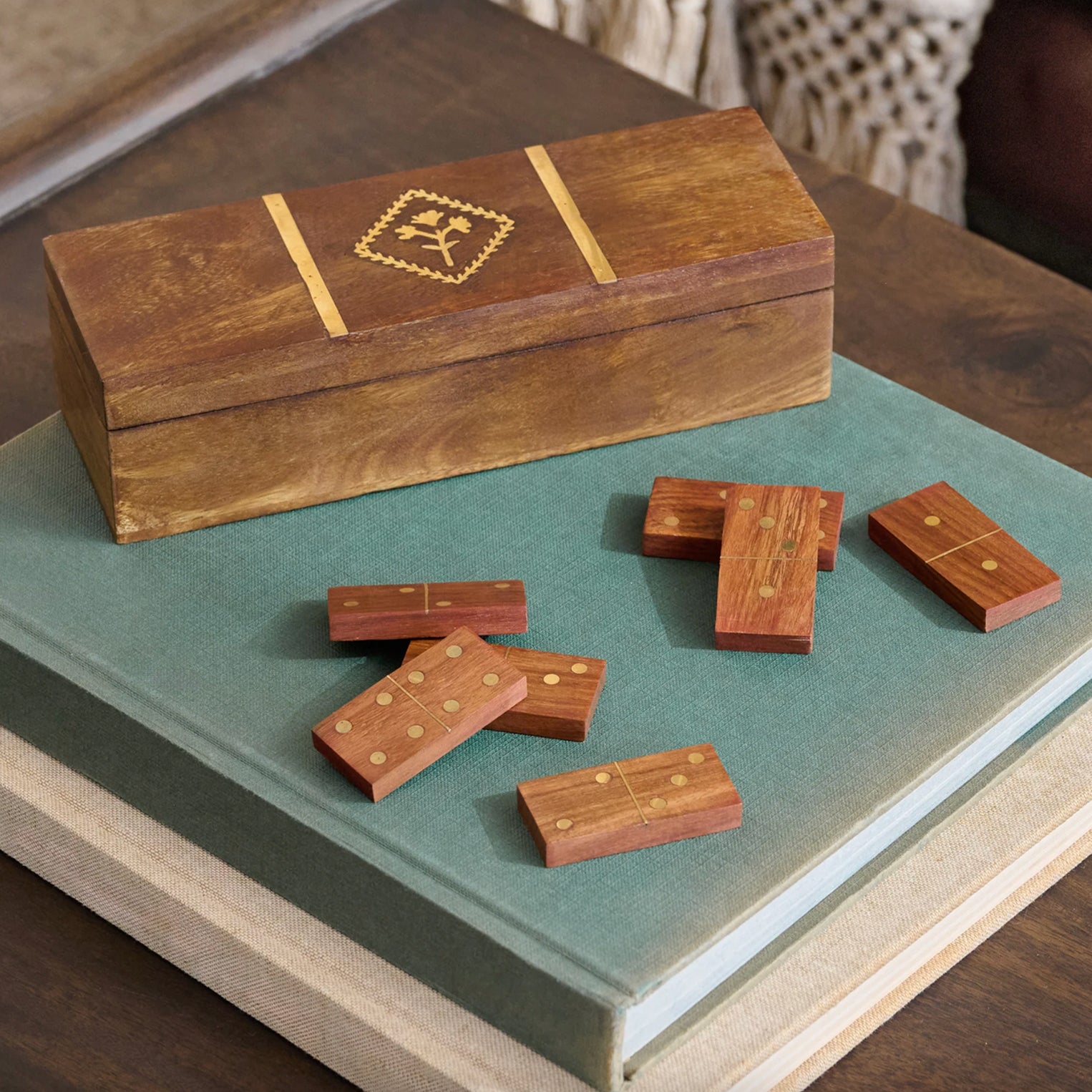 Wooden domino set with a matching box on a table