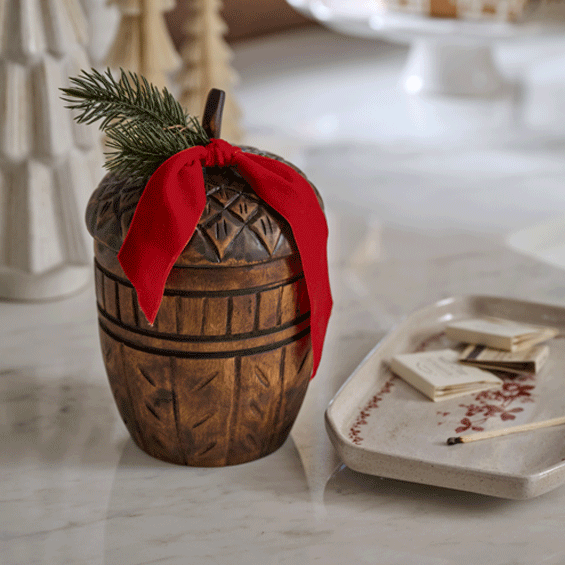 GIF of a holiday candle with cover coming off, being lit, flame  showing and then flame going out.