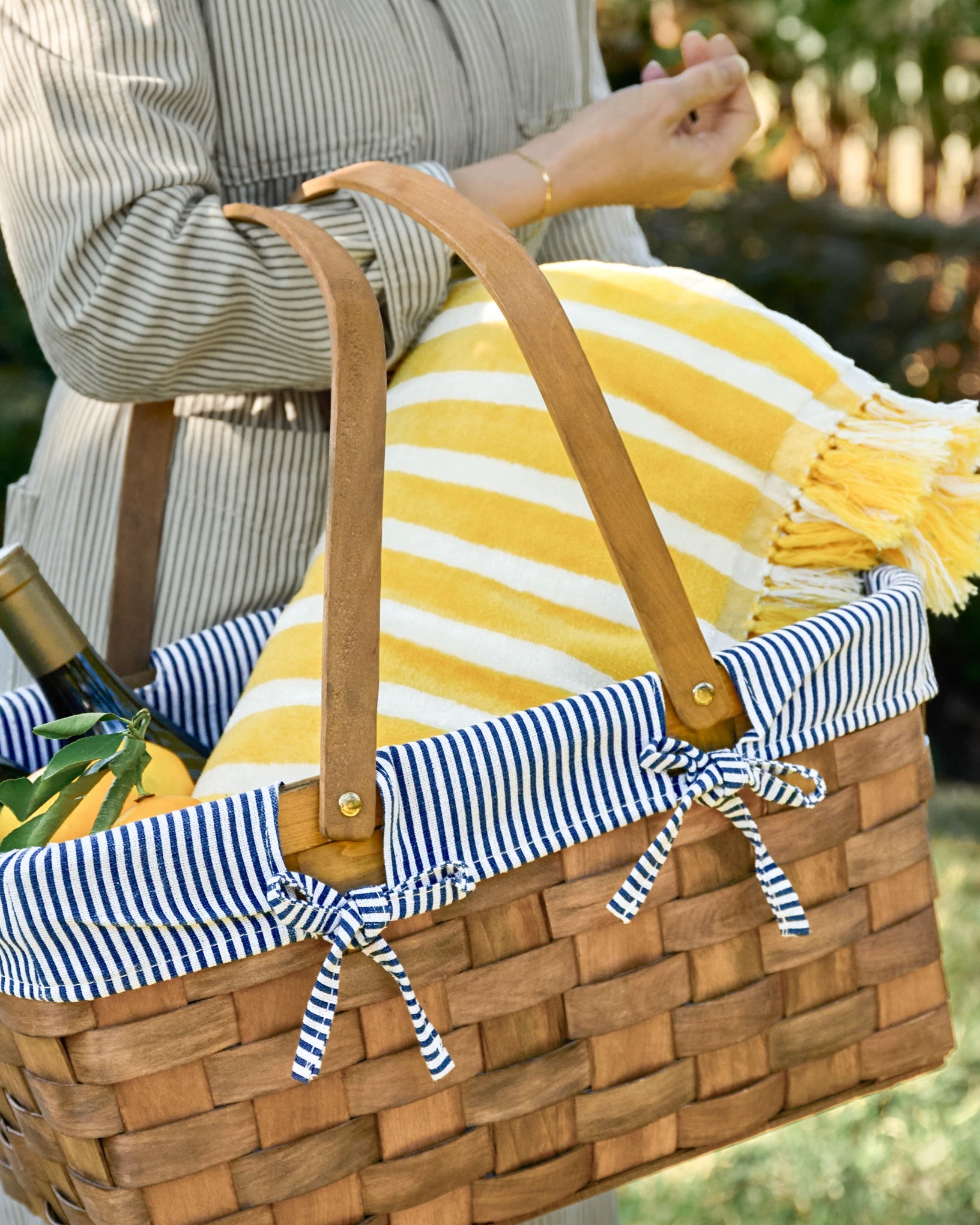 Kansas Handwoven Picnic Basket shown holding icnic supplies