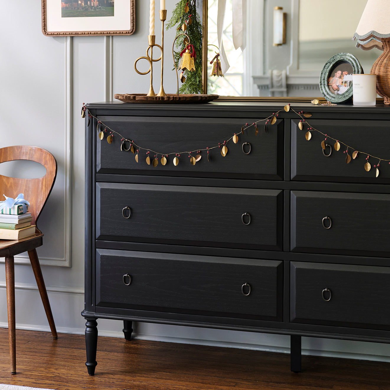 Black dresser with decorative elements in a room setting