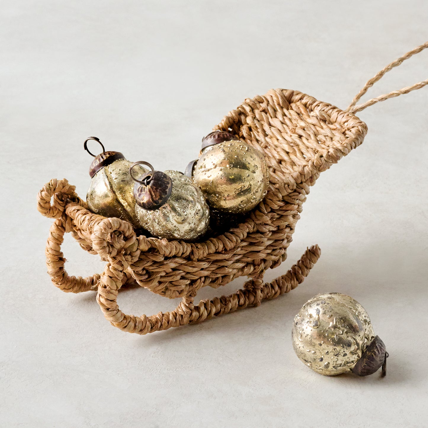 Rattan Sleigh Ornament shown with mini ornaments