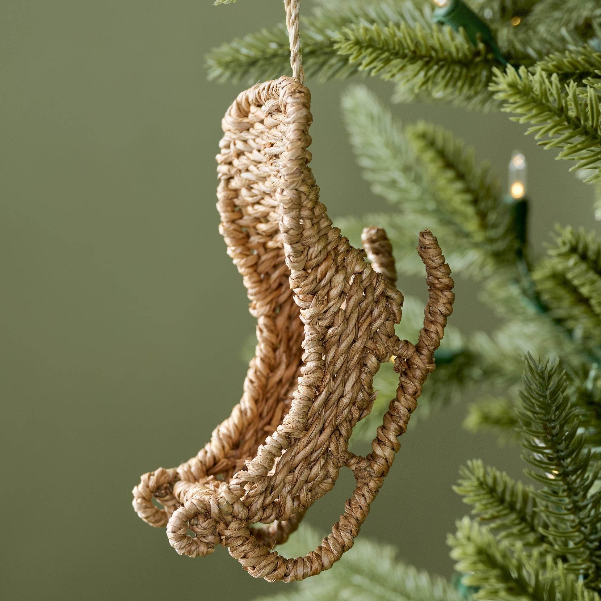 Rattan Sleigh Ornament shown on tree