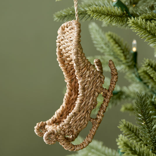 Rattan Sleigh Ornament shown on tree