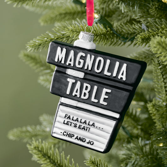Magnolia Table Blown Glass Ornament shown on tree