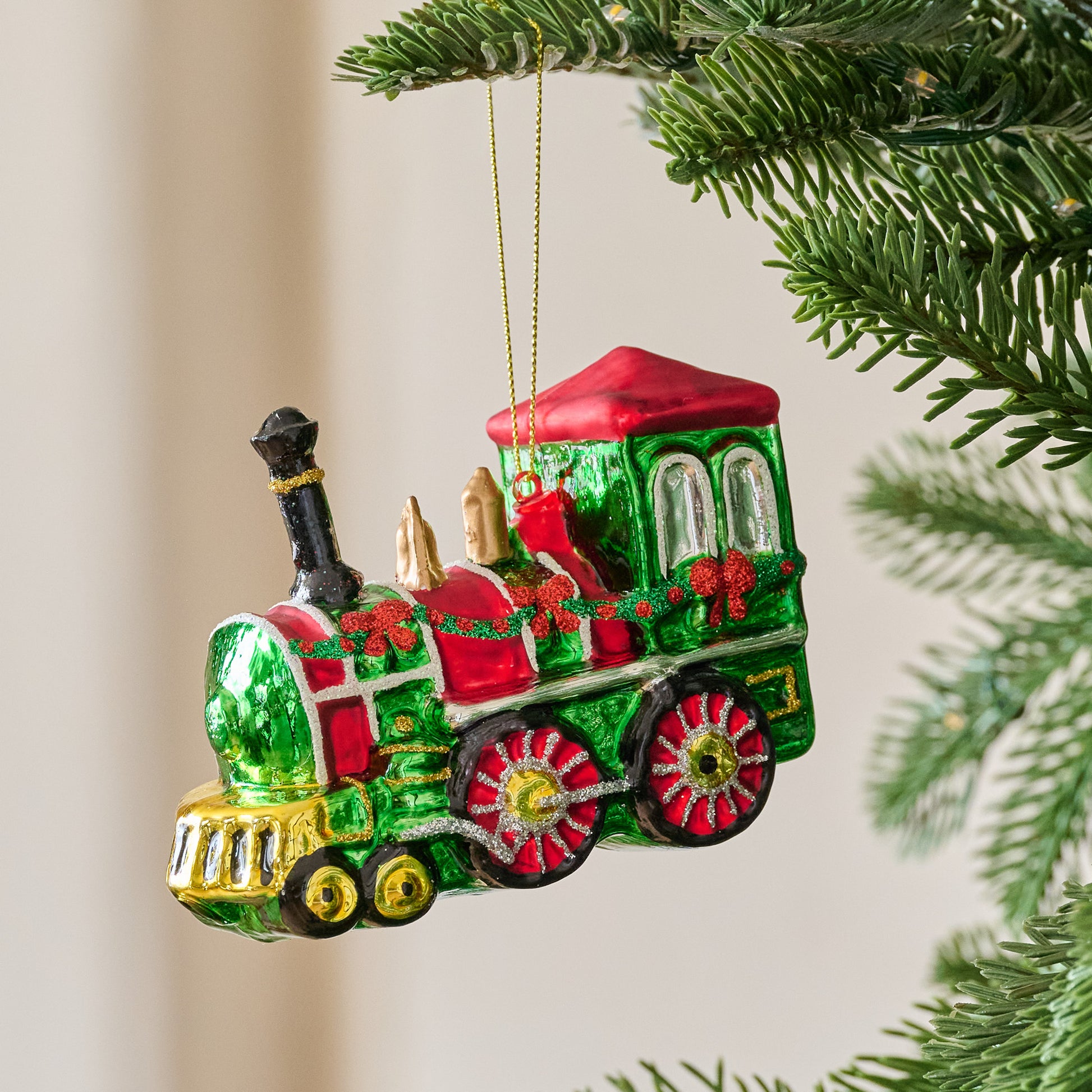 Vintage-Inspired Blown Glass Train Ornament shown on tree