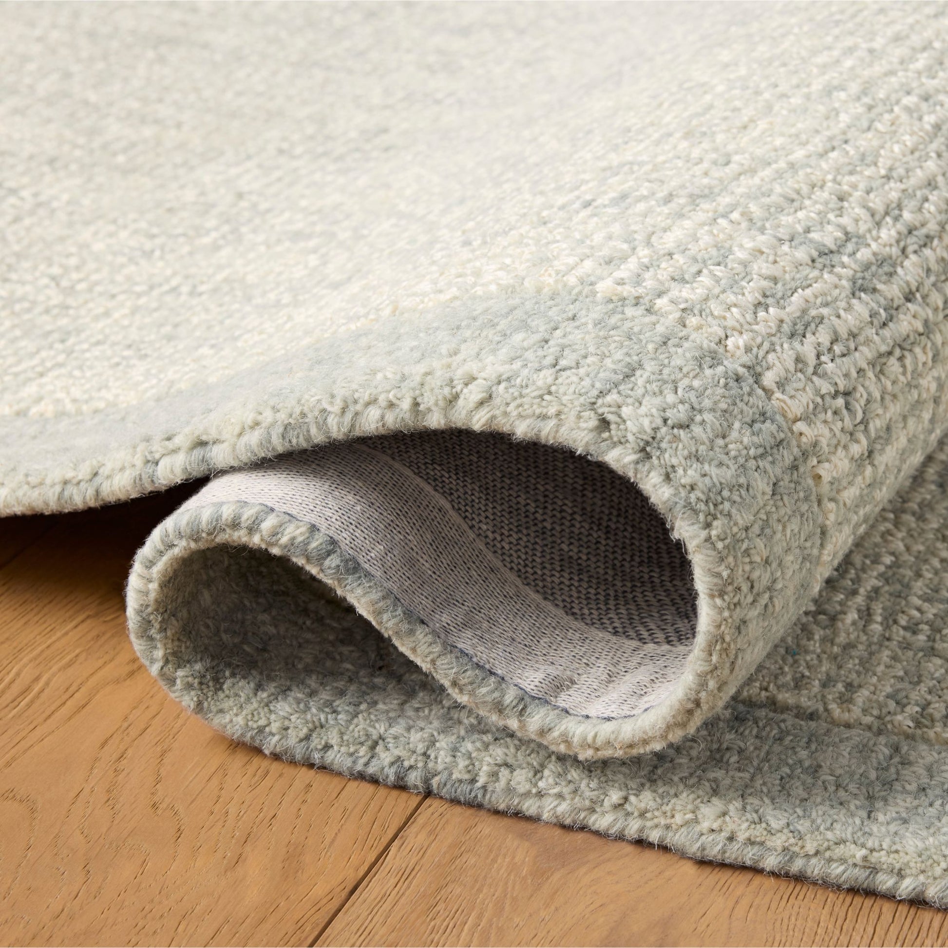 Henley Ivory Spa Rug shown rolled/folded
