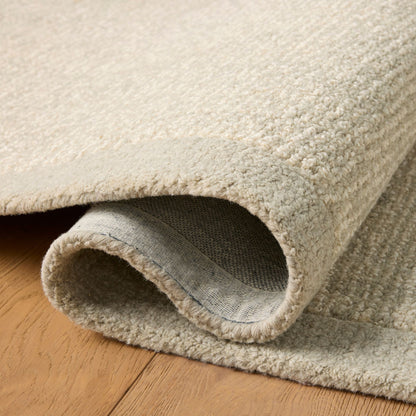 Henley Ivory Silver Rug up close shown rolled/folded
