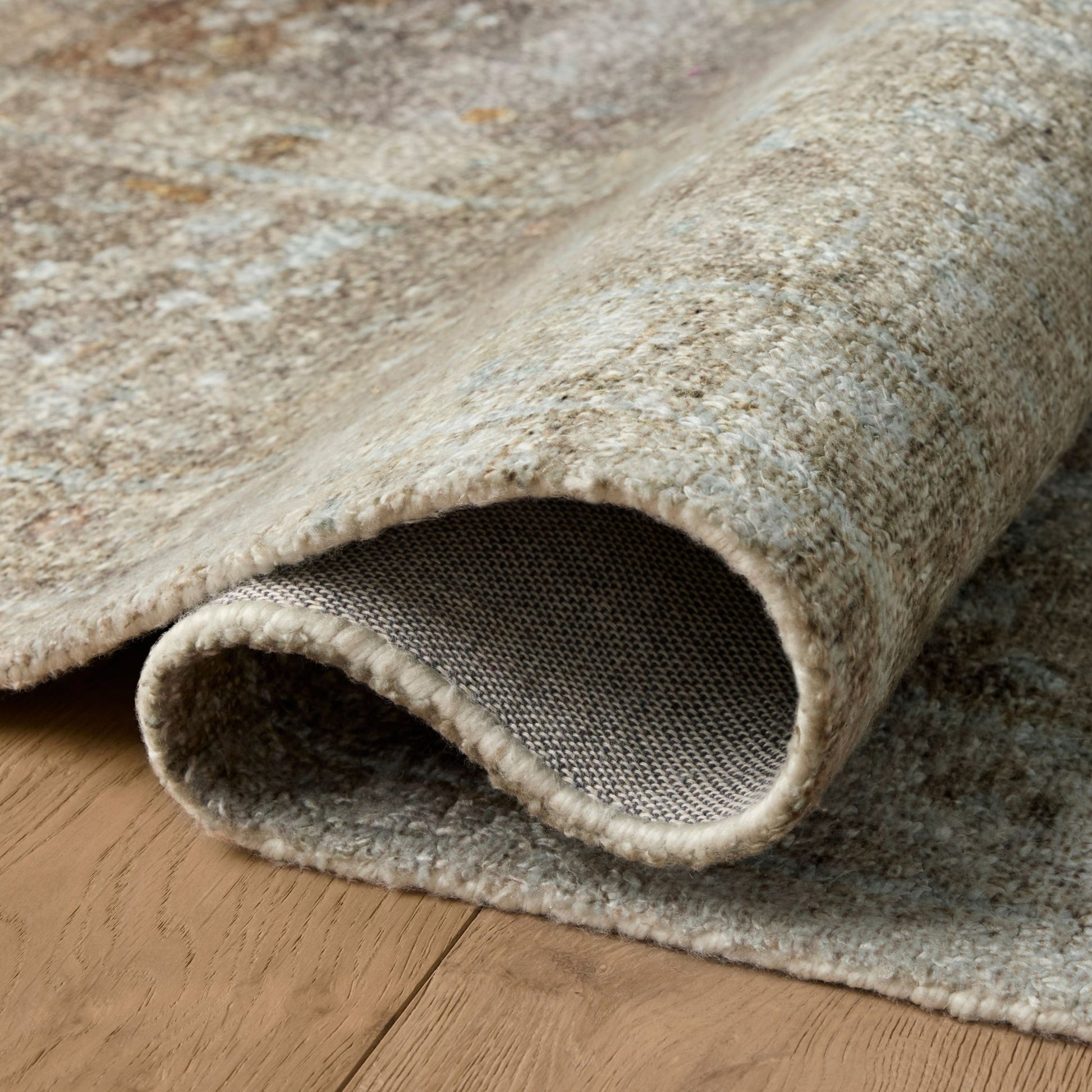 Wimberly Earth Multi Rug shown rolled/folded
