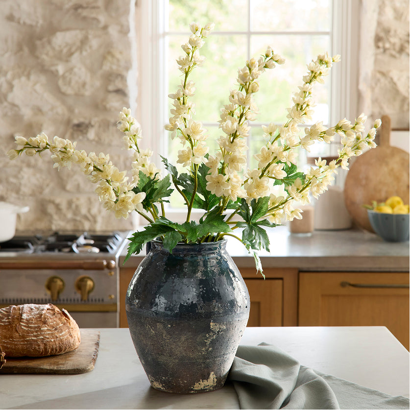 Vase with white flowers on a kitchen counter