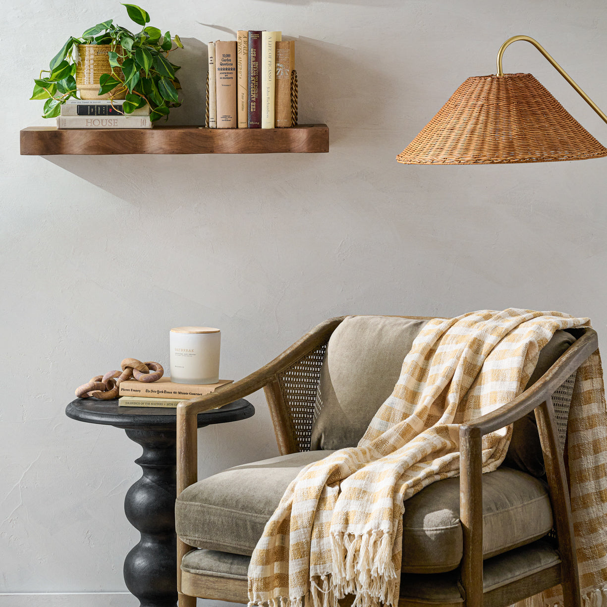 Hollis Accent Chair with a throw blanket on top next to a side table