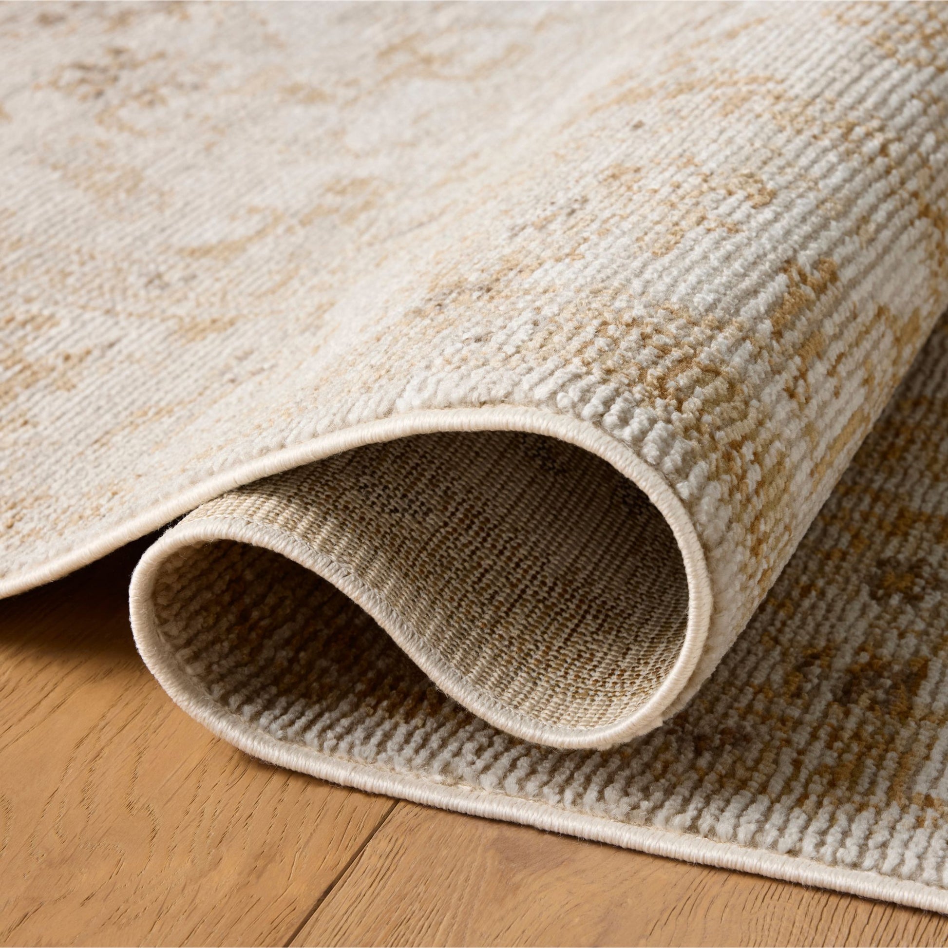 Pace Natural Gold Rug shown rolled/folded