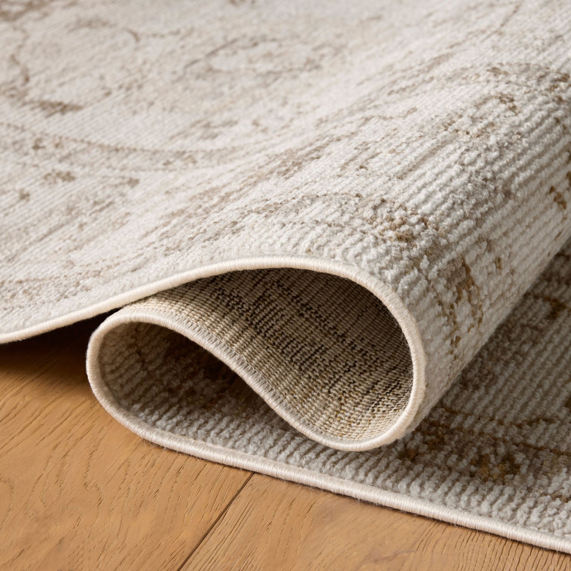 Pace Natural Stone Rug shown rolled/folded