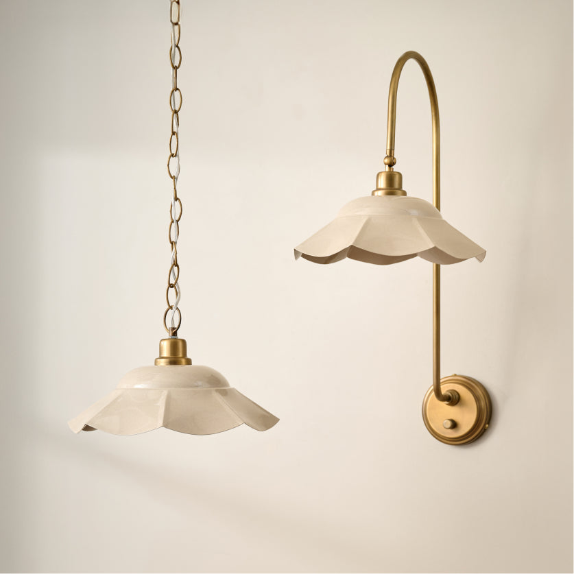 an ivory metal scalloped hanging light fixture along side the same ivory scalloped light fixture, but a wall sconce.