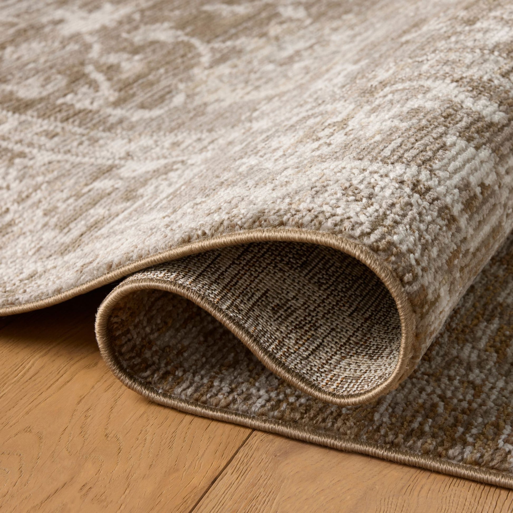 Pace Bark Natural Rug shown rolled / folded