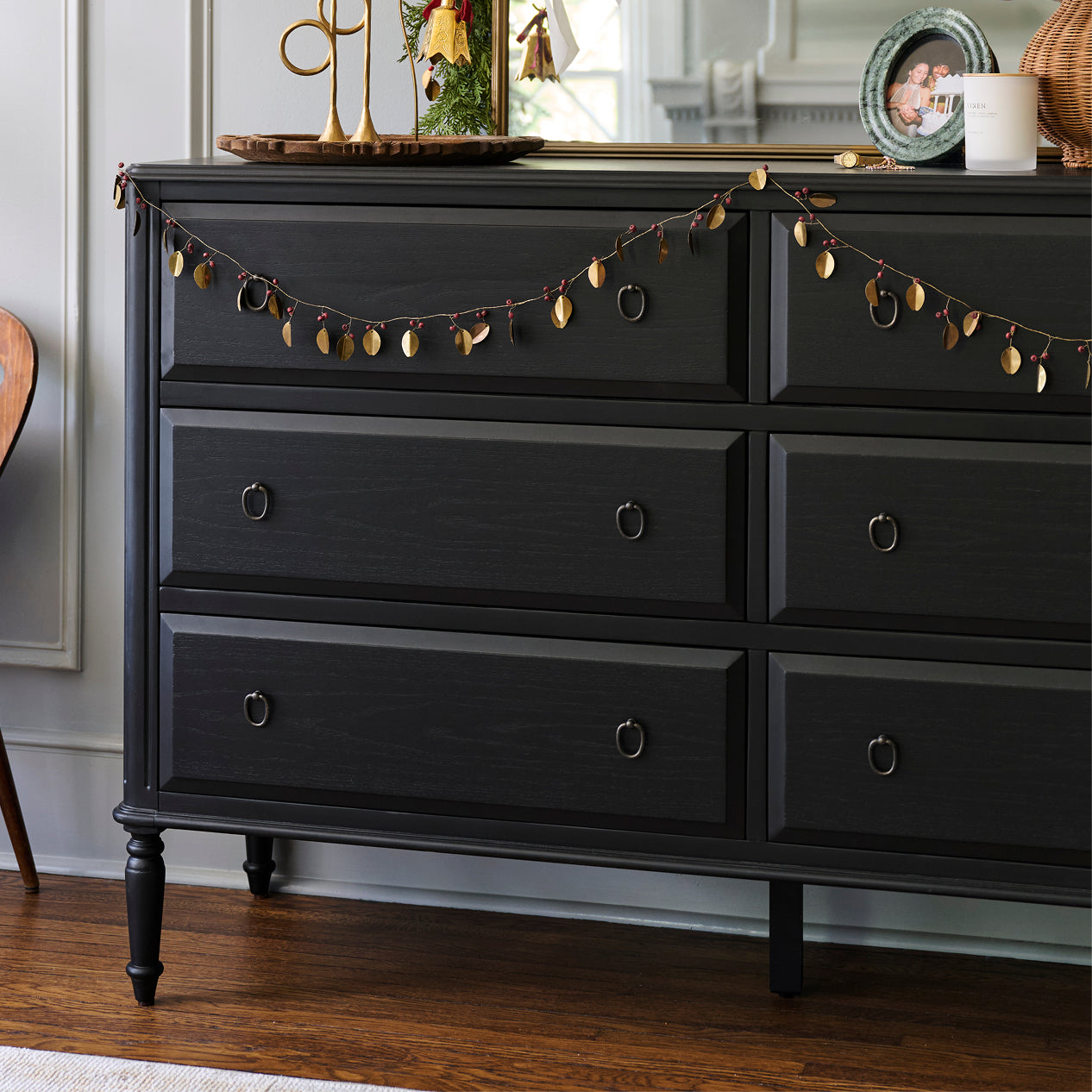 Black dresser with decorative elements in a room setting