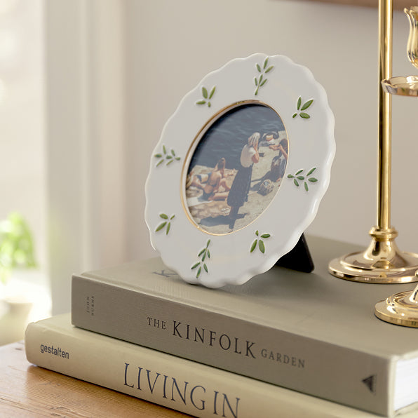 Decorative plate with a floral design on top of books