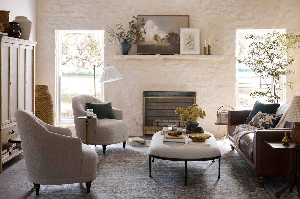 Living room with gray armchairs, a coffee table, and a fireplace.