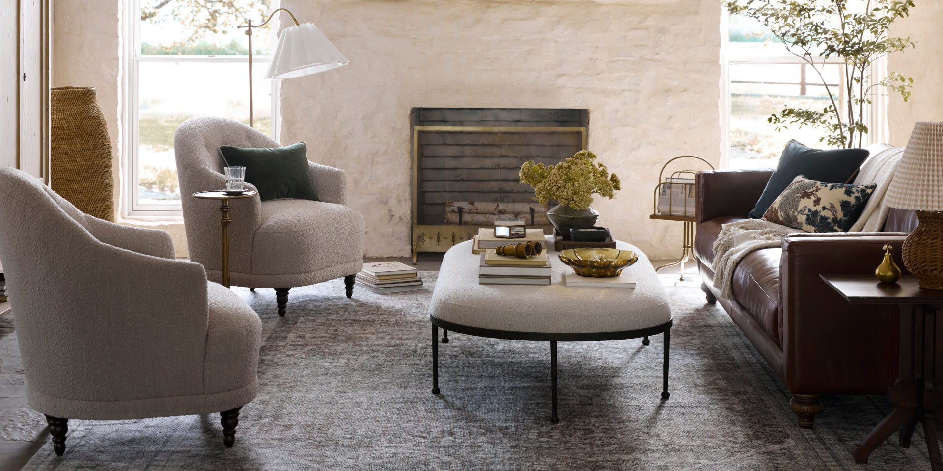 Living room with a fireplace, sofa, chairs, and coffee table.