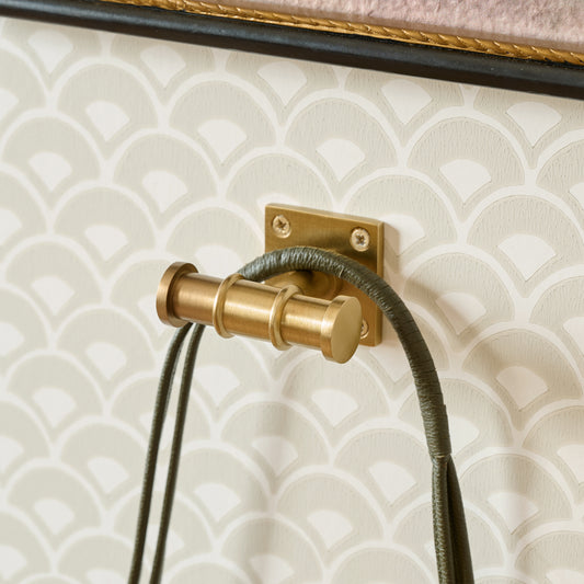Louis Brass Wall Hook shown hung on wall