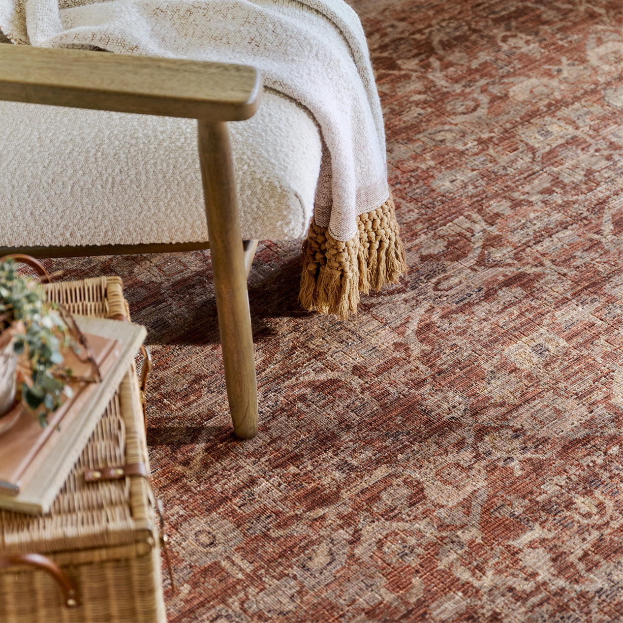 Patterned rug with a wooden chair and wicker table in a room setting