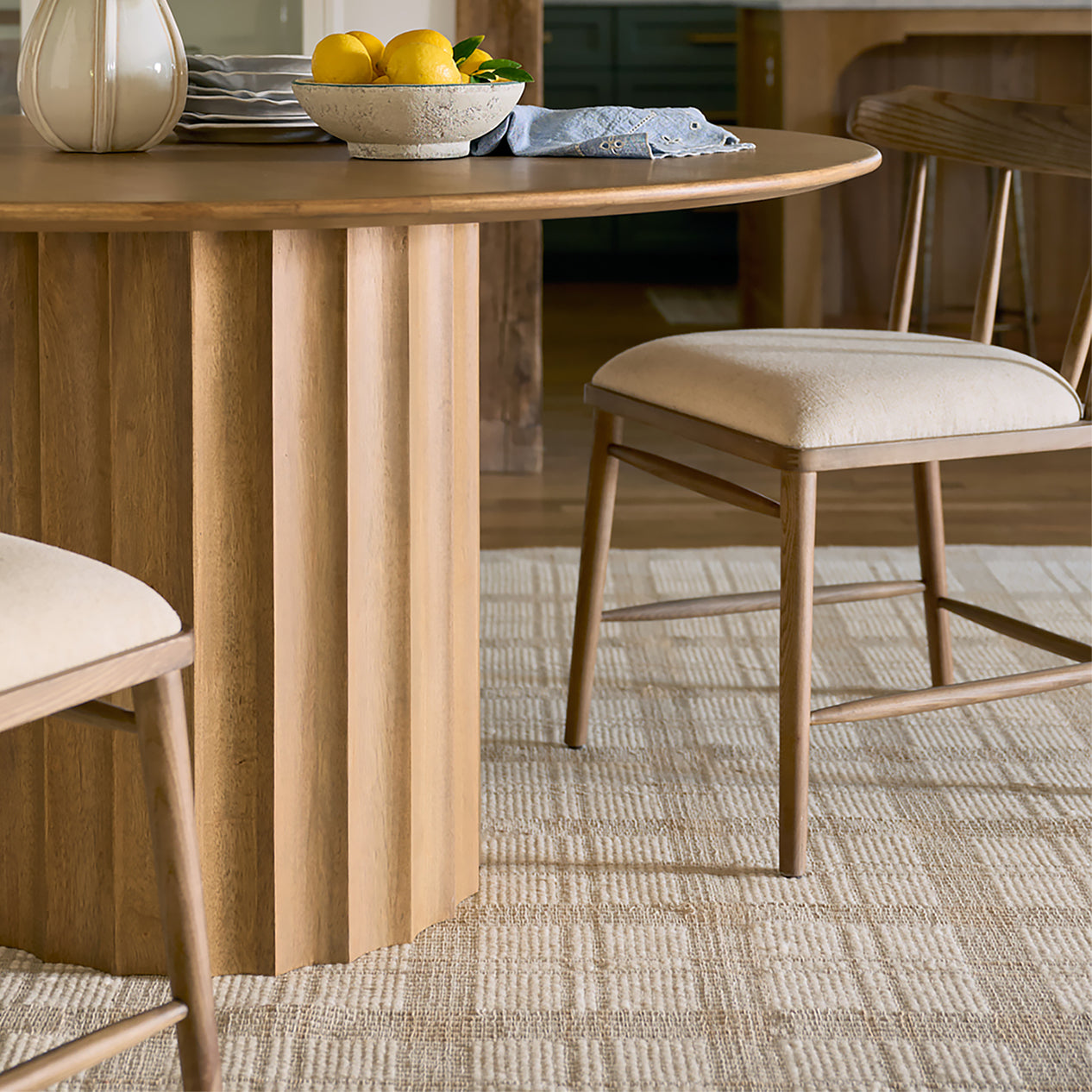 Wooden dining table with chairs in a room setting