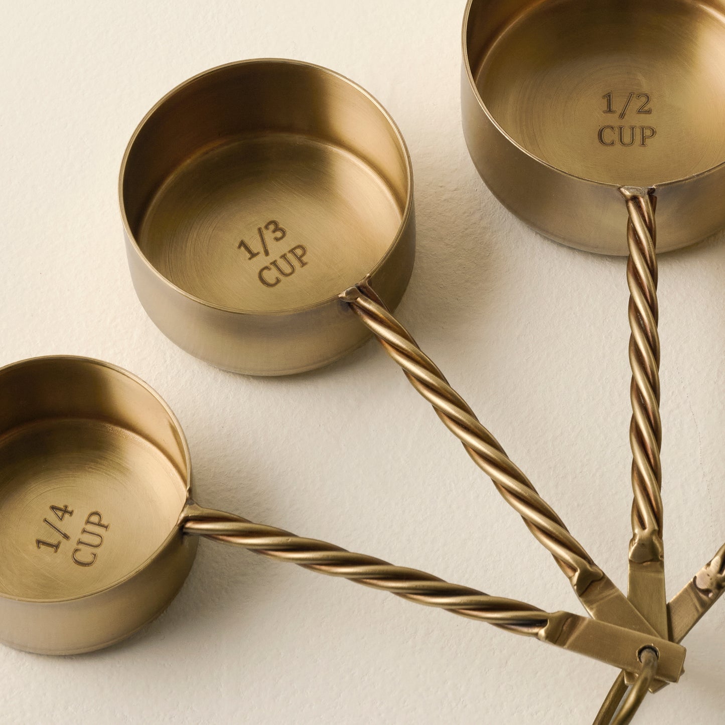 Antique Brass Twisted Measuring Cups up close