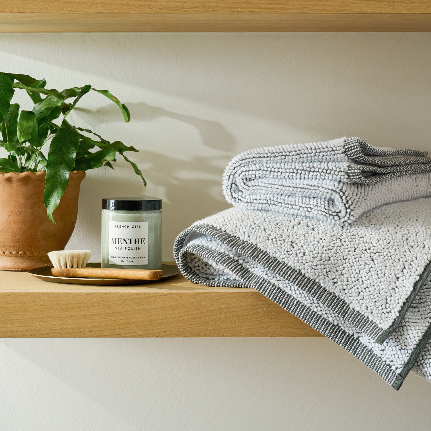 Terracotta Garden Scalloped Edge Pot on a shelf in a bathroom
