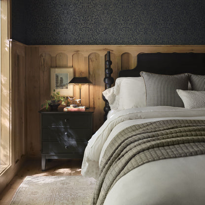 Cozy bedroom with wooden aspen headboard, nightstand, and decorative pillows.