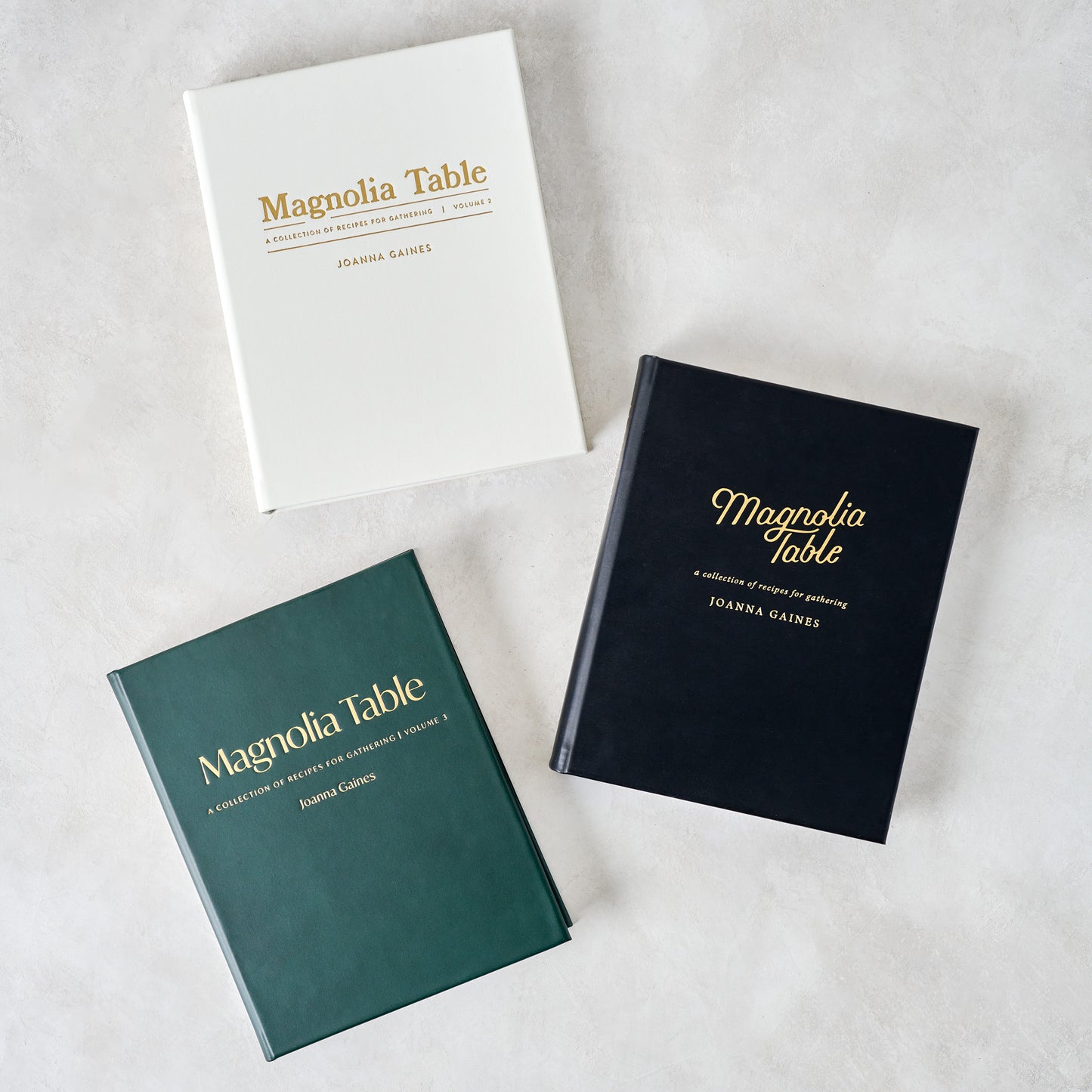 Leather Bound Magnolia Table, Volume 2 shown with other volumes