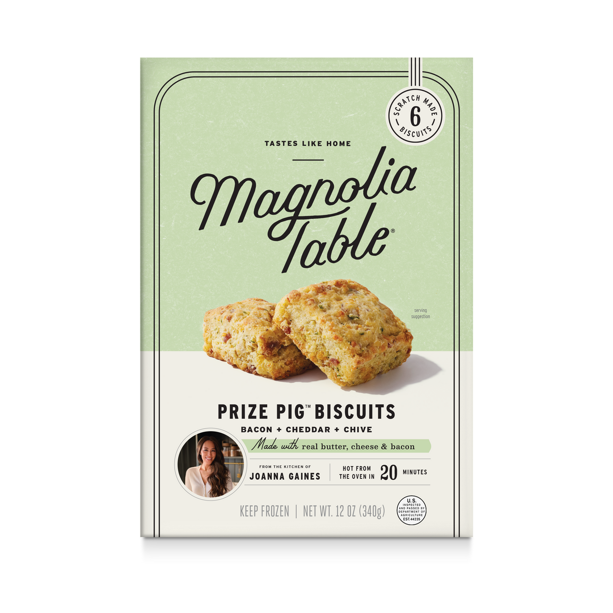 A package of Magnolia Table Prize Pig Biscuits, featuring a light green and cream color scheme with a photo of two baked biscuits on the front.