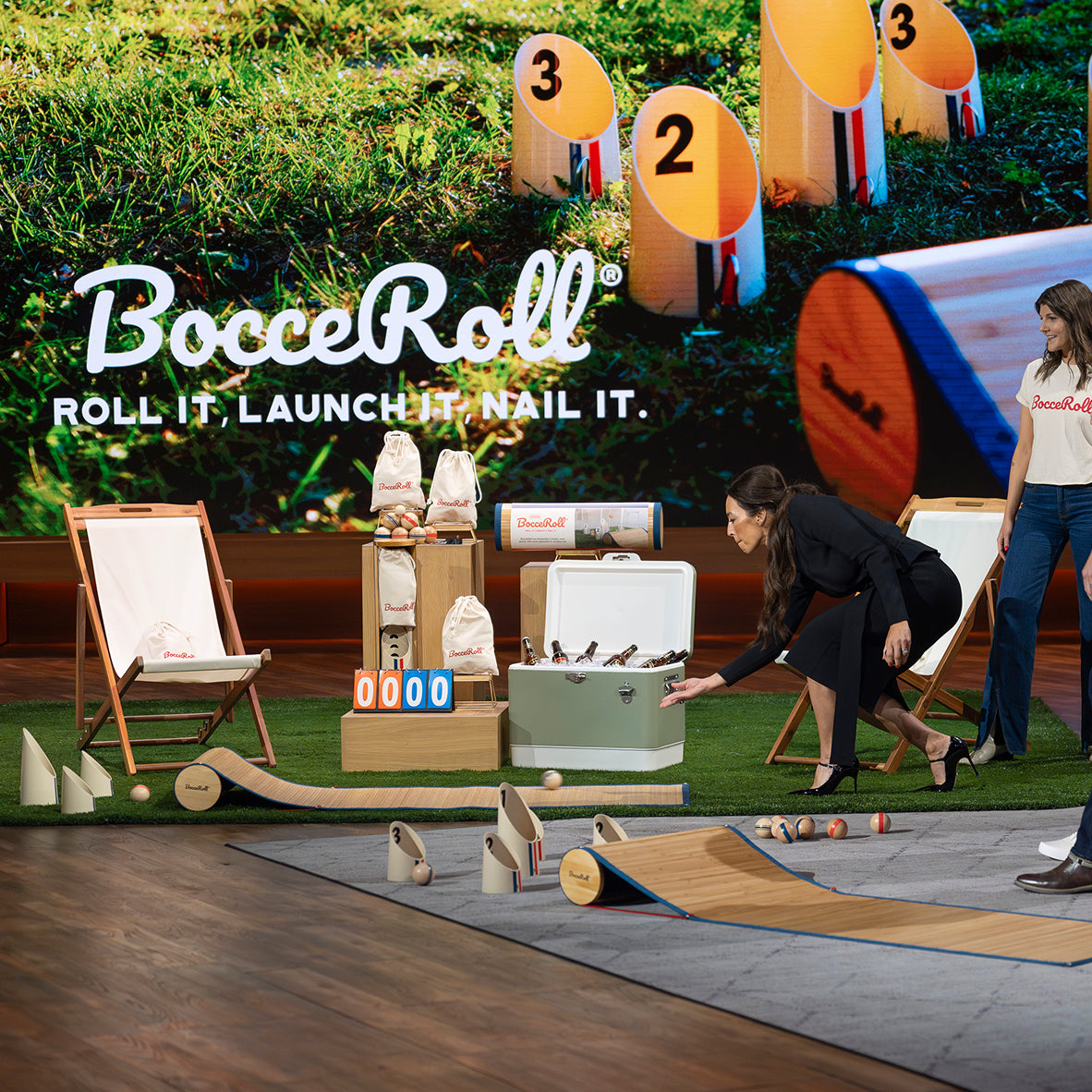 BocceRoll game setup with people interacting on a grassy area