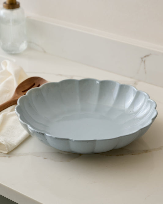 Oversized Grey Scalloped Serving Bowl shown on kitchen counter