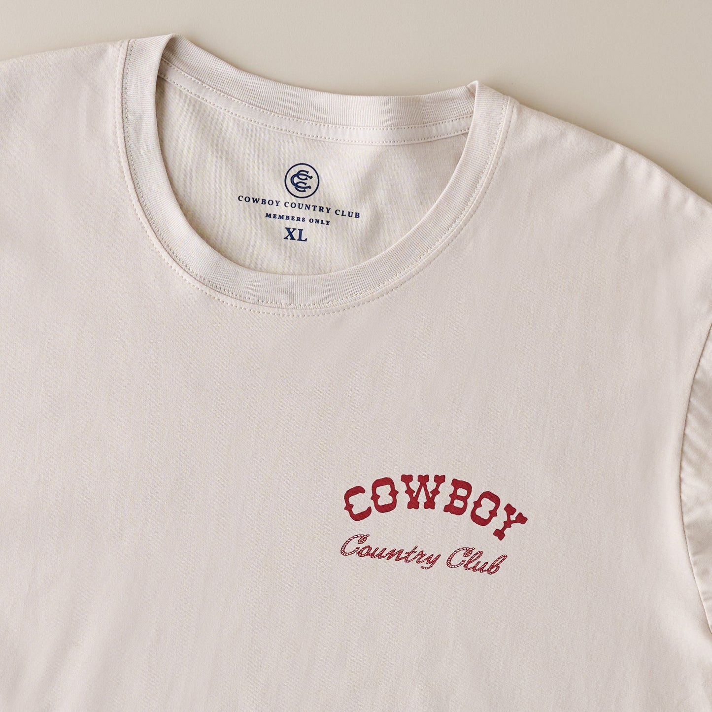 Cowboy Country Club Teeing Off Tan Shirt up close