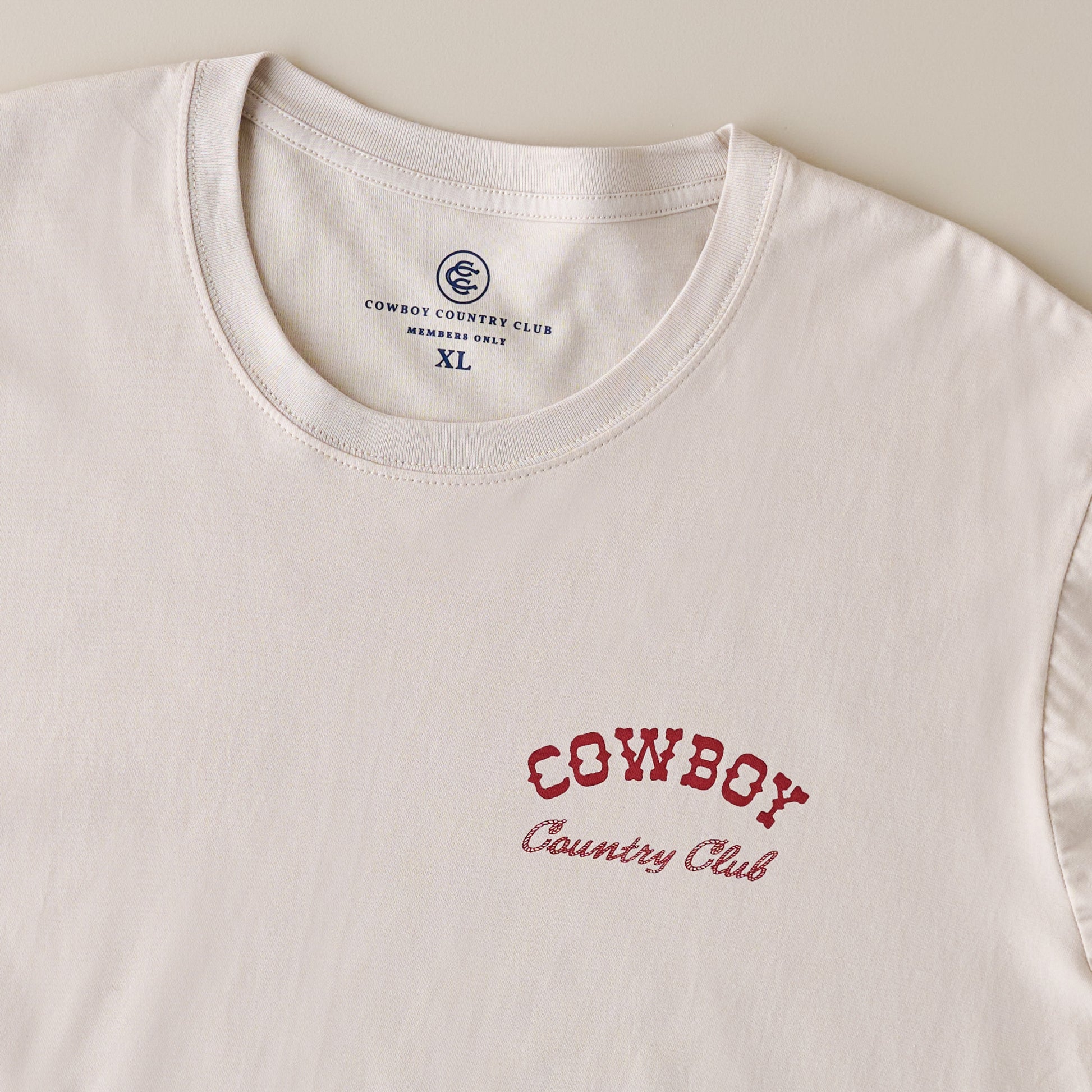 Cowboy Country Club Teeing Off Tan Shirt up close