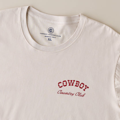 Cowboy Country Club Teeing Off Tan Shirt up close