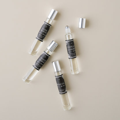 Cadillac Cowboy Roll On Cologne Oil shown with other colognes