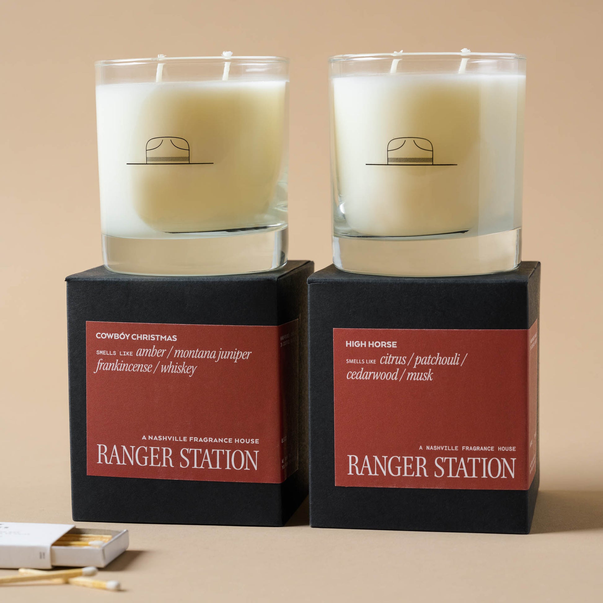 Ranger Station Cowboy Christmas Candle next to high horse candle