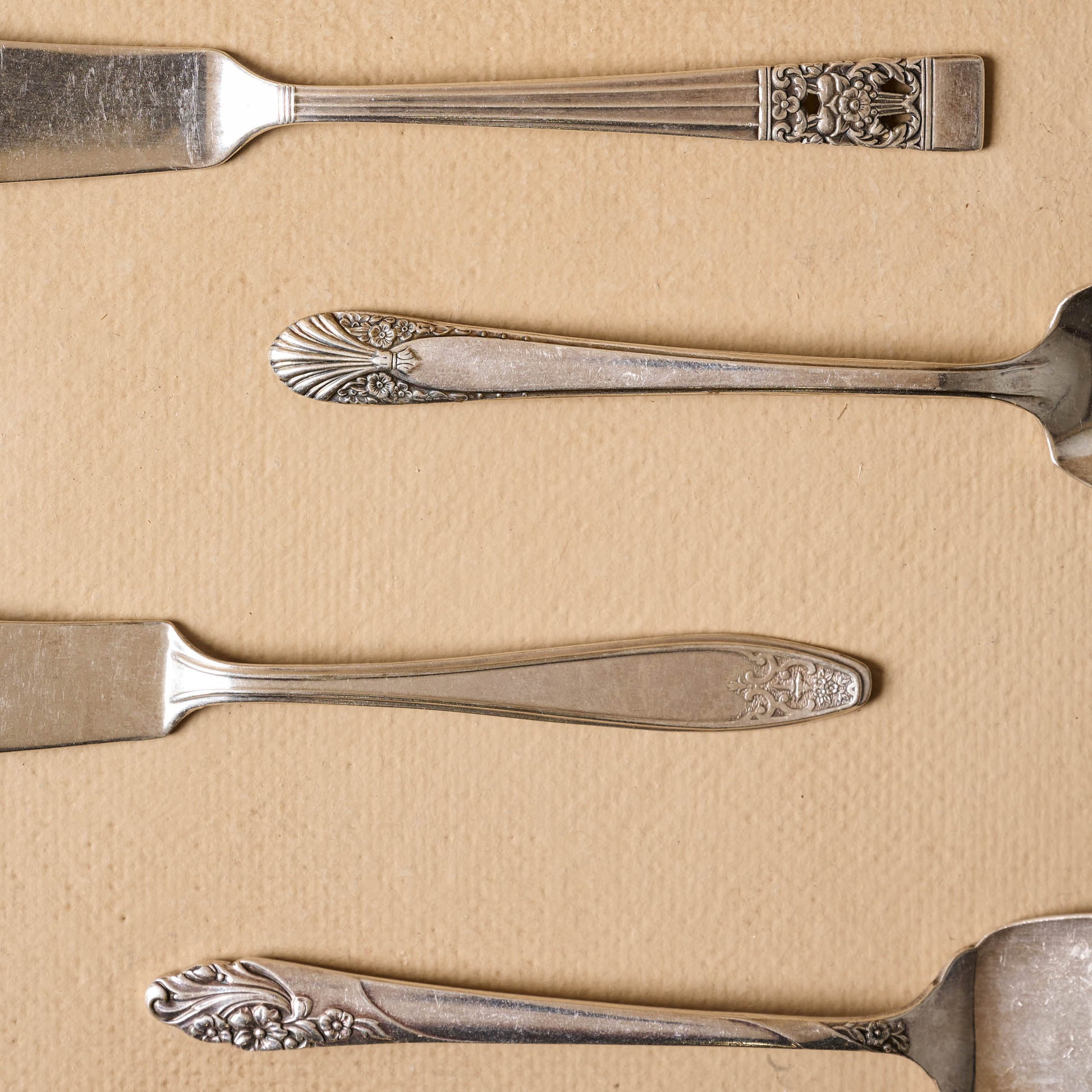 Vintage Silver Cheese Knife Set of Four close up of detail on handles of knives
