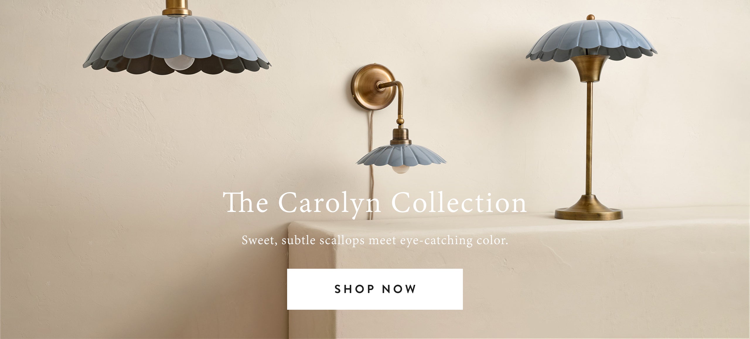 Three lamps from the Carolyn Collection on a beige wall.